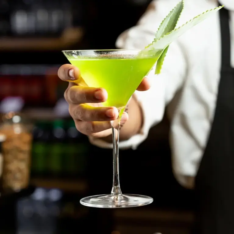yellow cocktail in barman hand